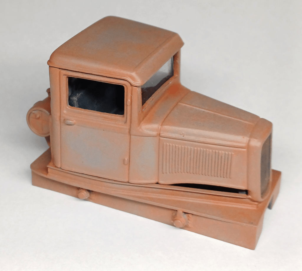 Adding windows to a model locomotive.