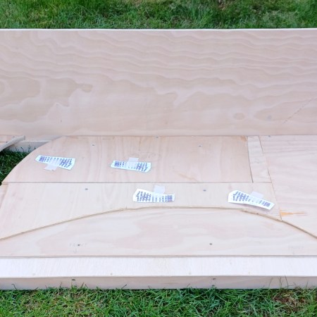 Assembled plywood model railway baseboard with point templates in position