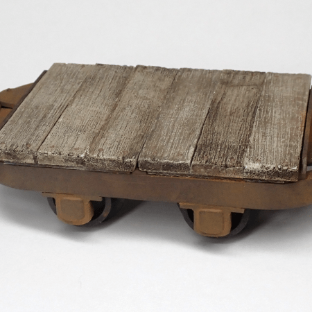 A 16mm scale narrow gauge model railway flat wagon using a Hudson tipper chassis